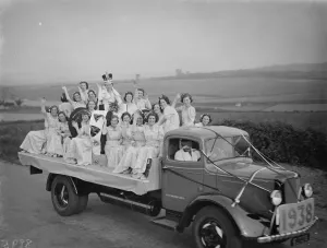 Crown Prints: The Dartford Carnival Queen with her attendees parade on a lorry. 1938