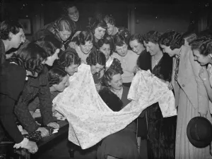 Shopping Prints: The Dartford Carnival Queen choosing a dress with her retinue. 6 April 1938