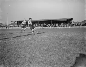 Dartford football club versus Guilford football club. A player plays the ball