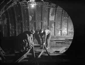 Frame Prints: The Dartford tunnel men working the pipes. 1938