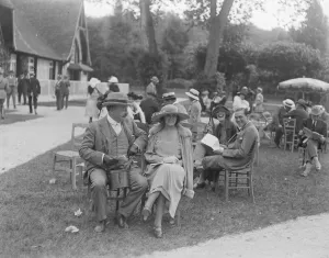 Sitting Prints: The Deauville Season. Mr Bob Sievier with Madame Rosetti. 13 August 1921
