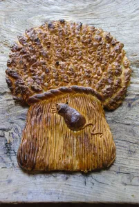 Decorative loaf in shape of sheaf of wheat with mouse for harvest festival credit
