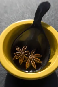 Dried Star anise fruits in small bowl. Also known as star aniseed, badiane or Chinese