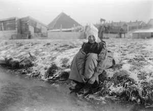 A Dutch Idyll A charming photograph of a jolly little Dutch girl preparing for