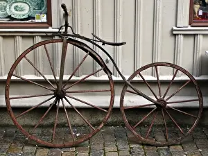 Ladies Prints: Early bicycle against wooden painted wall of antique shop in Haga district of Gothenburg