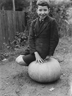 Grow Collection: Edward Harrison from North Cray, Kent, poses with the pumpkin that he grew. 1938