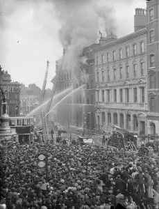 Elephant and Castle warehouse in flames, tremendous crowds watch. Fires involving