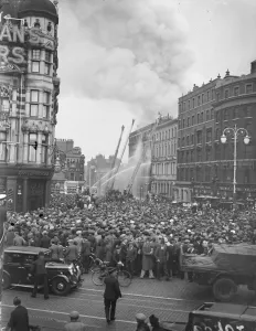 Elephant and Castle warehouse in flames, tremendous crowds watch. Fires involving