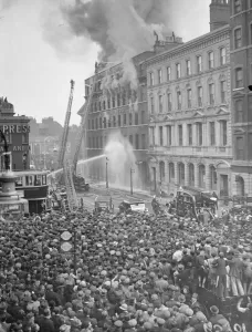 Elephant and Castle warehouse in flames, tremendous crowds watch. Fires involving
