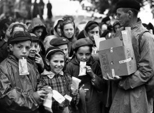 People Prints: On the embankment children wait to watch the Coronation procession are issued with