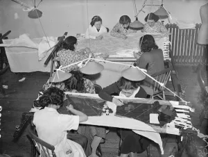 Embroiders at Hartnells, the Court dressmakers, are at work in London on exquisite