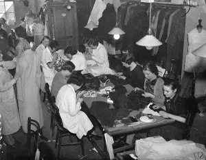 Embroiders at Hartnells, the Court dressmakers, are at work in London on exquisite