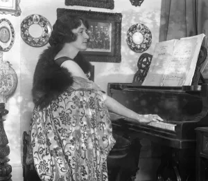 Actress Prints: English actress, Miss Marjorie Hume seated at her piano