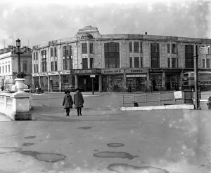 Street Collection: The entrance to the Arcade and other shops on the promenade on Worthing seafront. 1926