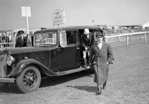 Hats Prints: Epsom Downs Spring Meeting Surrey Jockey Gordon Richard arrives by car. 18 April 1939