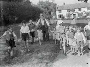 Evacuated children in Wye, Kent, walking down a country road. 1939 / 40