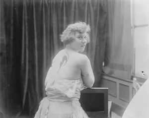 Fashions Latest Craze Miss Mona Vivian with her pet cat painted on her shoulder