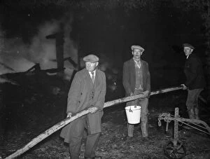 Fire Collection: A fire at Chaplins Farm, Hockenden. Farm workers hold the hoses