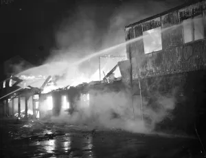 Flames Prints: Fire, Halls, Dartford. Fire hoses being trained on the burning building