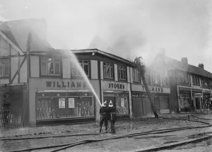 Firemen attempt to put out fires in a parade of shops in Welling, Kent