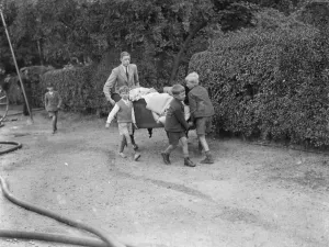 Firemen respond to a house fire in Chislehurst, Kent. Locals try and salvage