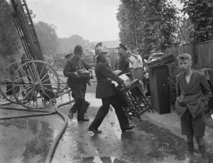 Firemen respond to a house fire in Chislehurst, Kent. Firemen and policeman try