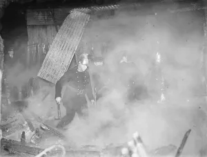 Firemen tend to a fire at the Bull in Chislehurst, Kent. 1939