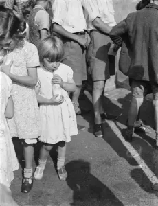 Free milk for children on holiday in Crayford, Kent. A little girl sips her milk