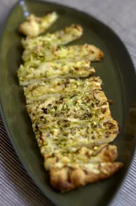 Freshly baked cheese straws made with grated courgette and grated emmental strewn