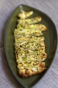 Freshly baked cheese straws made with grated courgette and grated emmental strewn