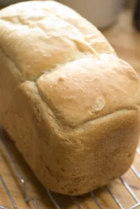 Freshly baked white loaf rack cooling on wire rack credit: Marie-Louise Avery /