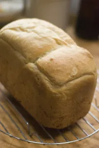 Freshly baked white loaf rack cooling on wire rack credit: Marie-Louise Avery /