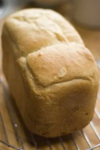 Freshly baked white loaf rack cooling on wire rack credit: Marie-Louise Avery /