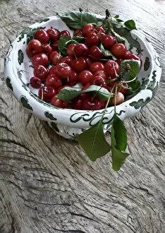 Leaves Collection: Freshly picked cherries from a Kentish garden in decorative pedestal bowl on rustic
