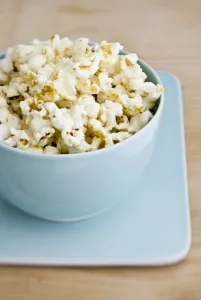 Freshly popped pocorn in pretty blue bowl credit: Marie-Louise Avery / thePictureKitchen