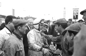 Driver Prints: Friends and fans gather round to congratulate John Surtees after he won the German