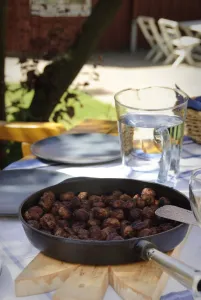 Glass Prints: Frying pan of Swedish meatballs on table outside in dappled summer sunshine credit