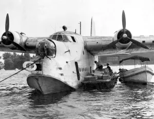 German workmen unload food from a British Royal Air Force flying boat, one of ten