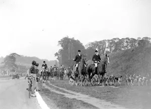 Horseback Prints: Girl cyclists watch the Royal Artillery (RA) drag hunt at Green St Green, Kent. 1934