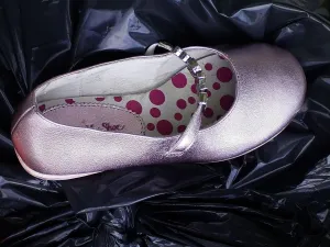 Smart Prints: Girls pink party shoe discarded on top of a black bin liner