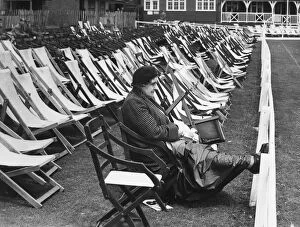 Spectator Collection: In glorious isolation, this hardy woman cricket enthusiast sat in the reserved
