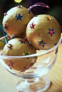 Decorative Prints: Gold christmas baubles with sequin stars in glass bowl as table centrepiece credit