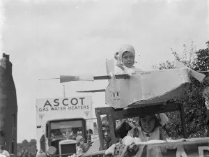 The Gravesend Carnival procession in Kent. A young aviator on his float