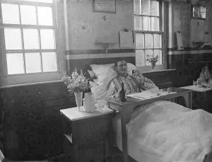 Ward Prints: Gravesend Hospital in Kent. A male patient in bed. 1939