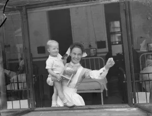 Ward Prints: Gravesend Hospital in Kent. Nurse with a child. 1939