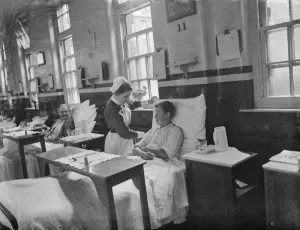 Apron Prints: Gravesend Hospital in Kent. Nurse with a young patient. 1939