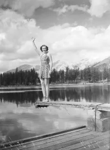 Greetings from the Canadian Rockies. A charming holidaymaker takes her giant hat off