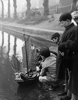 Playing Collection: Group of boys play with a model ship in Chislehurst Kent