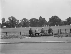 Playing Prints: A group of men watch a cricket game in Chislehurst. 1939