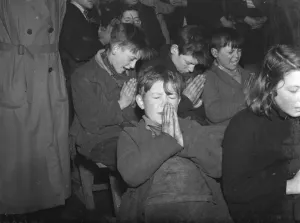 Gypsy childrens Sunday school in the cow shed in St Mary Cray. Children praying
